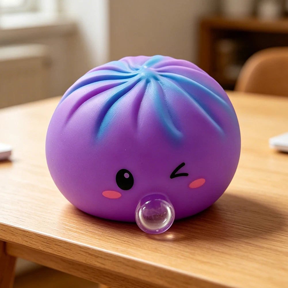 A purple, squishy dumpling-shaped stress relief toy with a clear bubble feature resting on a wooden table.