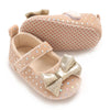 A pair of soft cotton baby walking shoes with anti-slip soles in a beige color.