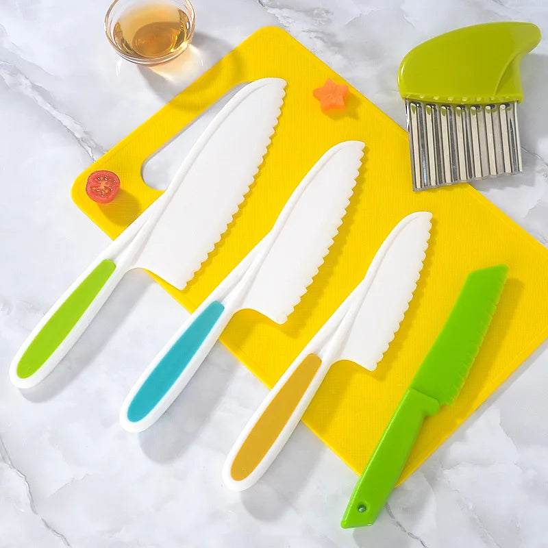 A set of five plastic play knives in white and green are displayed on a yellow background.