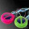 A pair of electric shock hand buzzer prank toys, one pink and one green, with lightning effects in the background.
