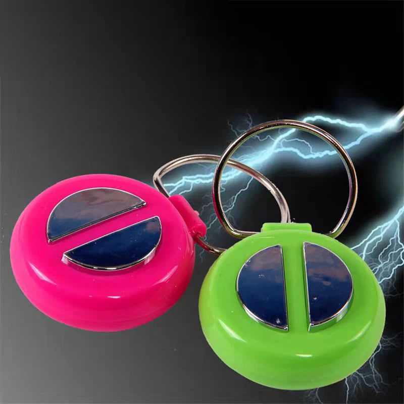 A pair of electric shock hand buzzer prank toys, one pink and one green, with lightning effects in the background.