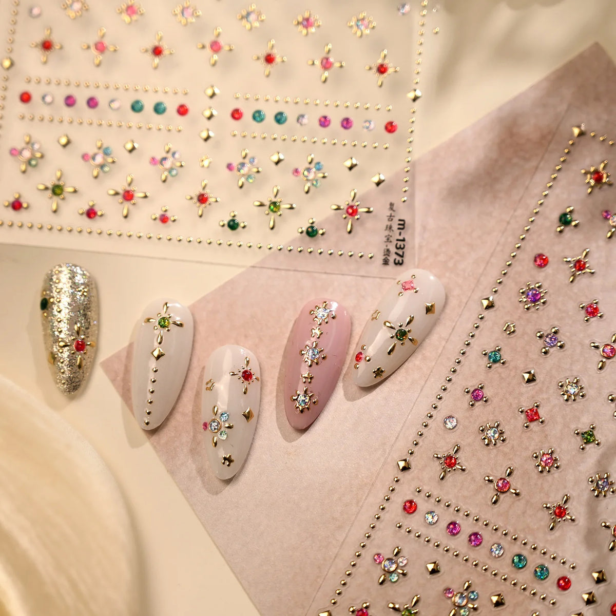 Close-up of sparkling 5D diamond nail art stickers arranged on a pink background.