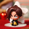 A mini figure collectible of a dark-haired character with intense eyes and black clothing, displayed on a clear stand.
