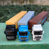 Three diecast model trucks, including a black Mercedes truck, a blue Mercedes truck, and a white Mercedes truck, are displaye