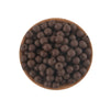 A pile of dark brown silicone round beads for jewelry making and DIY crafts resting on a wooden surface.