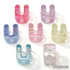 A collection of colorful acrylic alphabet beads shaped like the letter U, in shades of pink, purple, blue, and green.