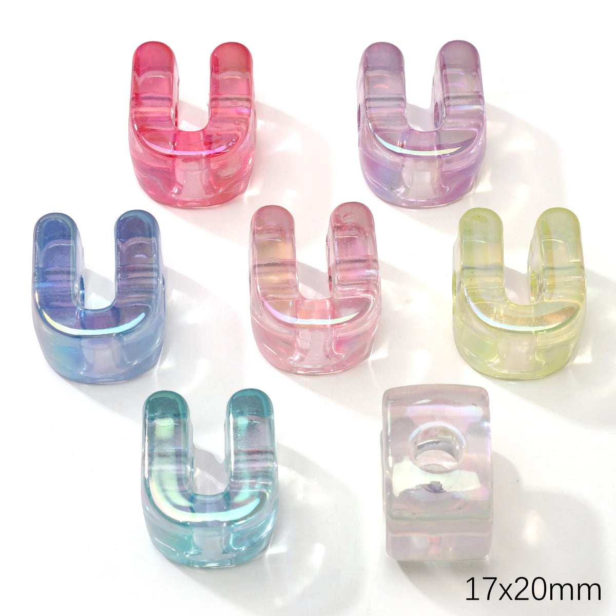 A collection of colorful acrylic alphabet beads shaped like the letter U, in shades of pink, purple, blue, and green.