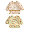 A set of two light-colored baby bibs with a floral pattern, one featuring small brown animals and the other with multi-colore