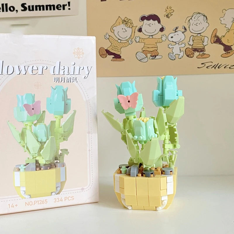 A miniature flower bouquet building block set featuring light green and pink flowers and leaves.