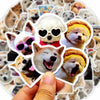 A hand holds a collection of funny dog stickers featuring various breeds and expressions.
