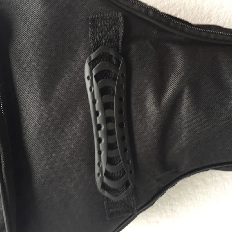 A close-up view of a black acoustic guitar bag featuring a textured strap and protective features.