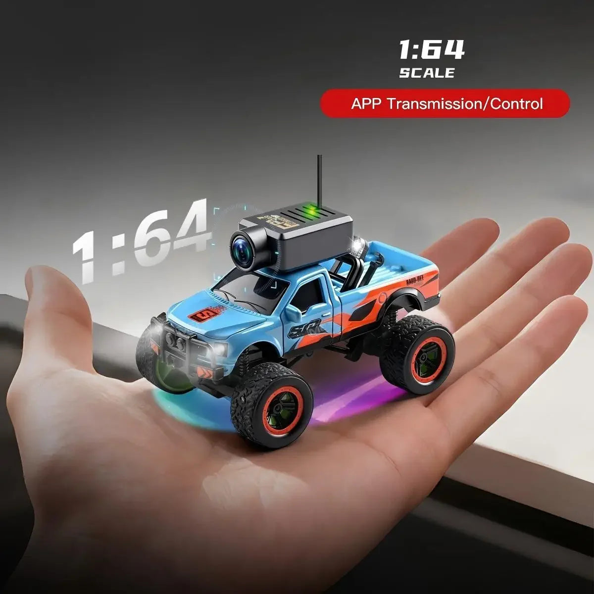 A blue 1:64 scale RC monster truck with an FPV camera is held in a person's hand.