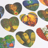 A collection of heart-shaped oracle tarot cards featuring vibrant colors and mystical imagery.