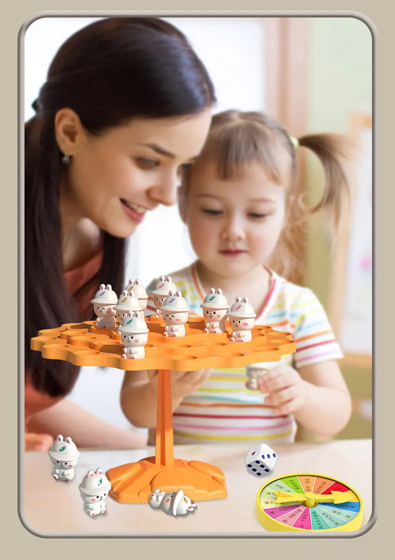 A young girl is playing with an orange frog balance tree math game featuring small frog figures and a yellow spinner.