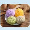 A collection of colorful, squishy bear-shaped stress relief fidget toys in purple, yellow, and green resting on a wooden surf
