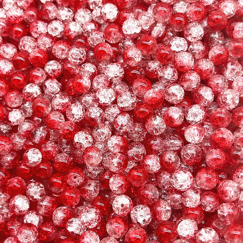 Close-up view of small, round, red glass crackle beads for jewelry making.