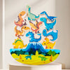 A colorful display of wooden dinosaur stacking blocks arranged in various sizes and colors on a white surface.
