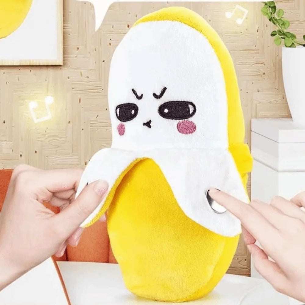 A yellow fruit induction metronome musical toy is being held by a hand, showing its soft texture.