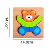A wooden puzzle shaped like a bear, featuring orange ears, a brown face, green arms, and blue legs.