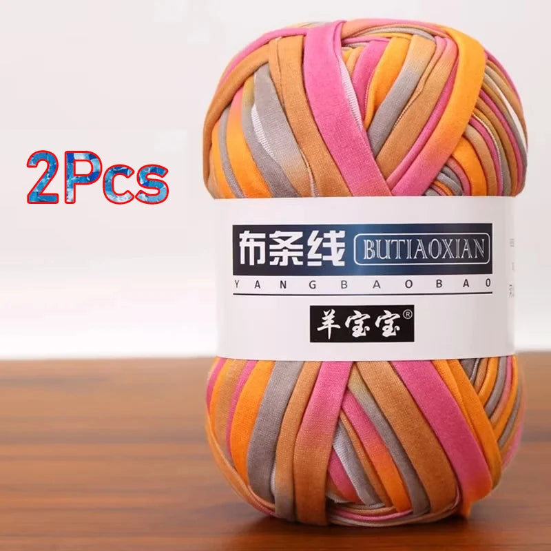 A skein of pink, orange, and gray chunky yarn is shown in a white label, packaged as a 2-pack.