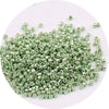 A pile of metallic glass beads, 2mm in size, packaged for jewelry making.