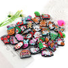 A collection of festive Christmas silicone beads and charms for jewelry making arranged on a white surface.