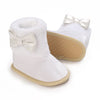 White baby first walker shoes with silver bow accents and tan soles