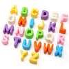 A collection of colorful acrylic letter beads in uppercase and lowercase forms arranged on a white background.
