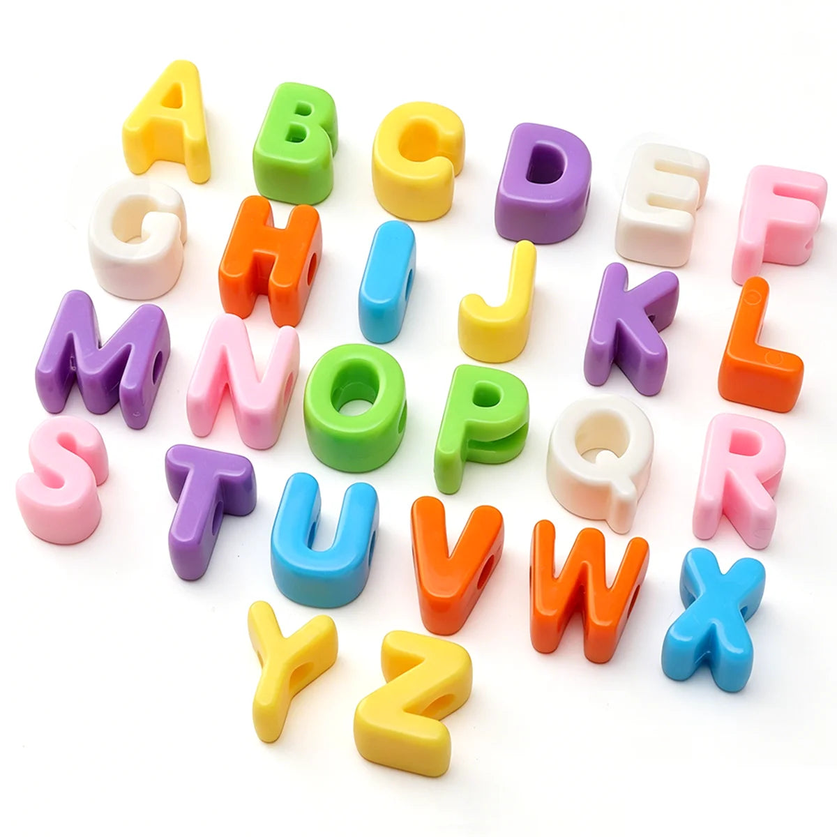 A collection of colorful acrylic letter beads in uppercase and lowercase forms arranged on a white background.