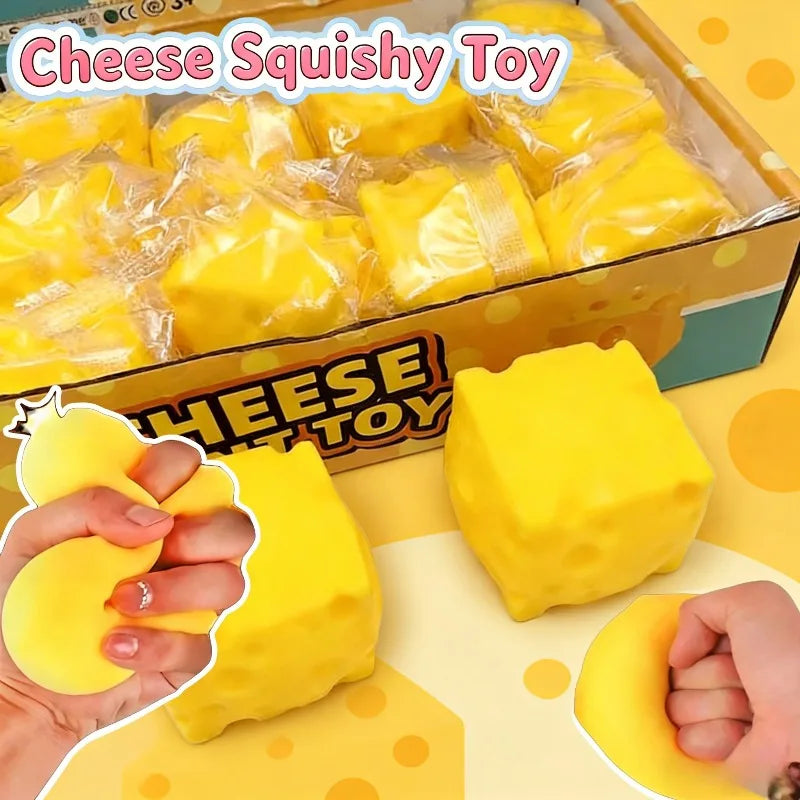 A box of yellow cheese squishy toys is shown alongside a hand squeezing one of the soft, yellow fidget toys.