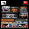 A display of 1:64 scale modular cars inside a garage with acrylic showcases and detailed interiors.
