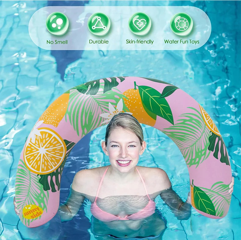 A young woman is lying on a pink and green U-shaped inflatable swim ring in blue water.