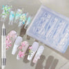 A clear silicone nail mold tray containing various floral designs and a carving pen.