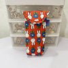 An orange fabric storage bag featuring repeating Miffy rabbit patterns, displayed inside a clear plastic storage box.