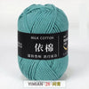 A ball of teal milk cotton yarn labeled YIMIAN 28 for knitting and crochet