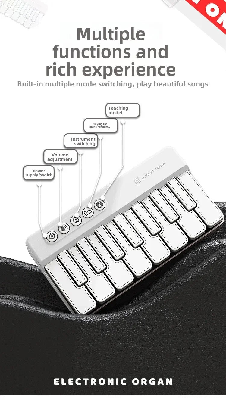A white 7-key mini electronic keyboard piano with multiple functions and lights is shown on a black fabric.