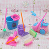 A set of mini dollhouse cleaning and medical accessories including a pink and blue cleaning brush, a purple brush, a pink spa