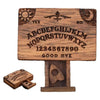 A wooden miniature Ouija board featuring an alphabet and yes no markings with a drawer.