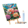 A paint by numbers kit featuring a vibrant floral and butterfly design on canvas.