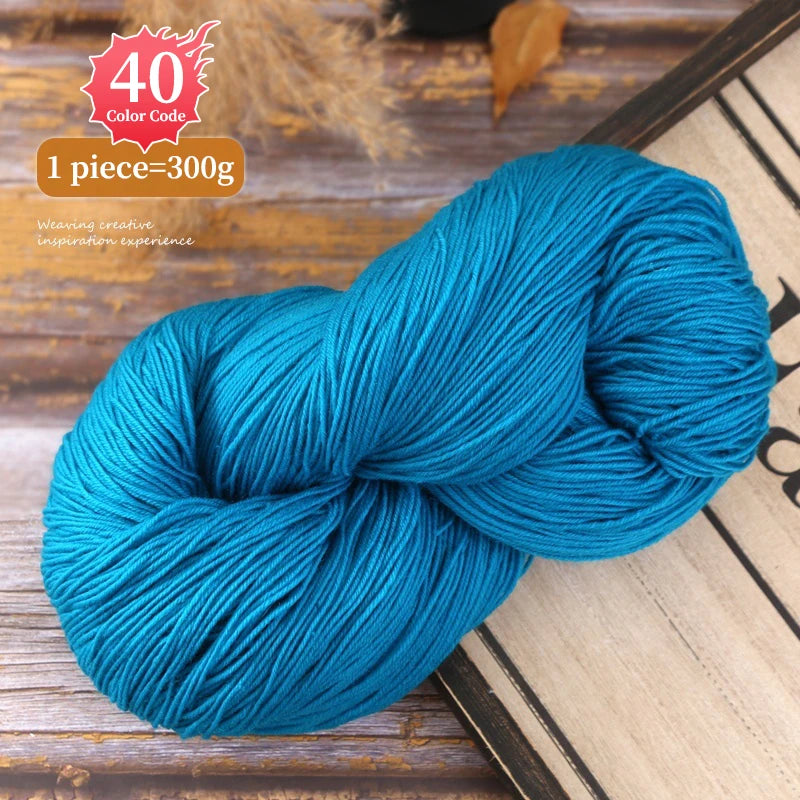 A skein of bright blue yarn is shown coiled on a wooden surface, with a label indicating 40 color code and 1 piece equals 300
