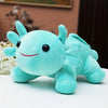 A soft turquoise axolotl plush toy with large eyes and pink accents sitting on a white surface.