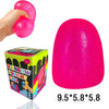 A bright pink squishy ball is shown being squeezed by a hand, next to its packaging and dimensions.