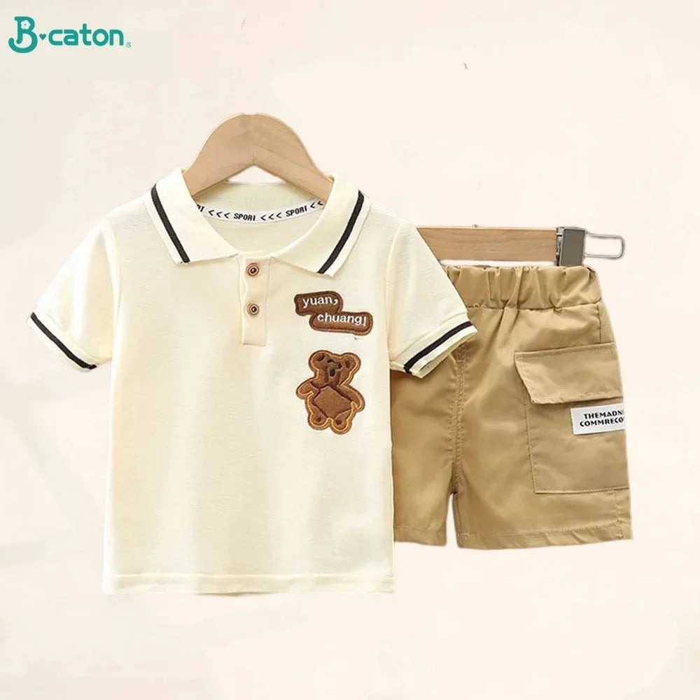 A beige boys' cotton summer short sleeve t-shirt and shorts set displayed on a wooden hanger.