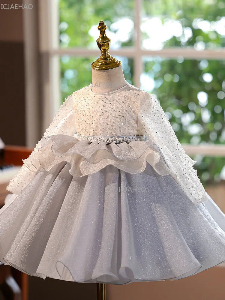 A white and gray tulle princess dress displayed on a mannequin.