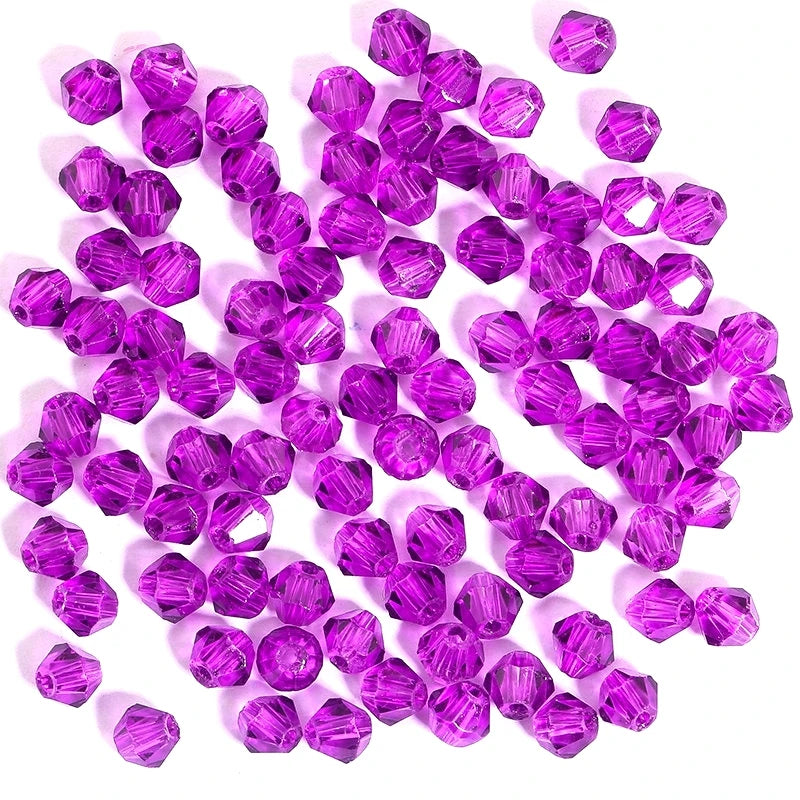 A cluster of small, faceted purple crystal bicone glass beads for jewelry making.