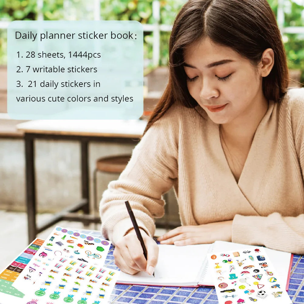A woman is writing in a notebook with a pen, surrounded by colorful daily planner stickers and sheets.