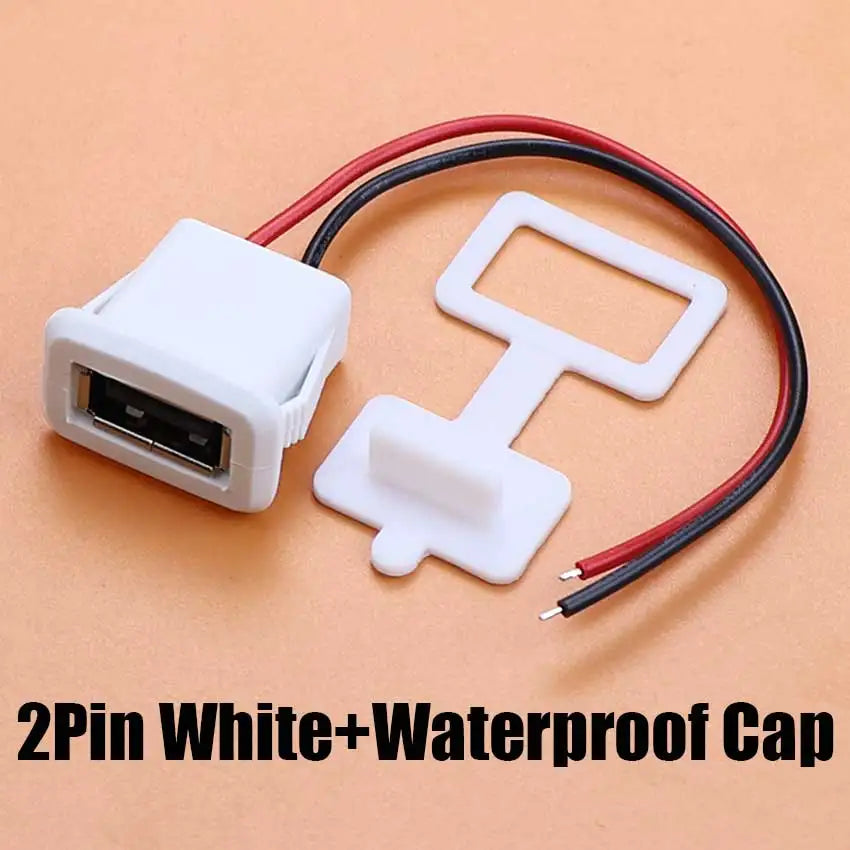 A white waterproof 2-pin USB connector with a red and black cable shown on a light brown background.