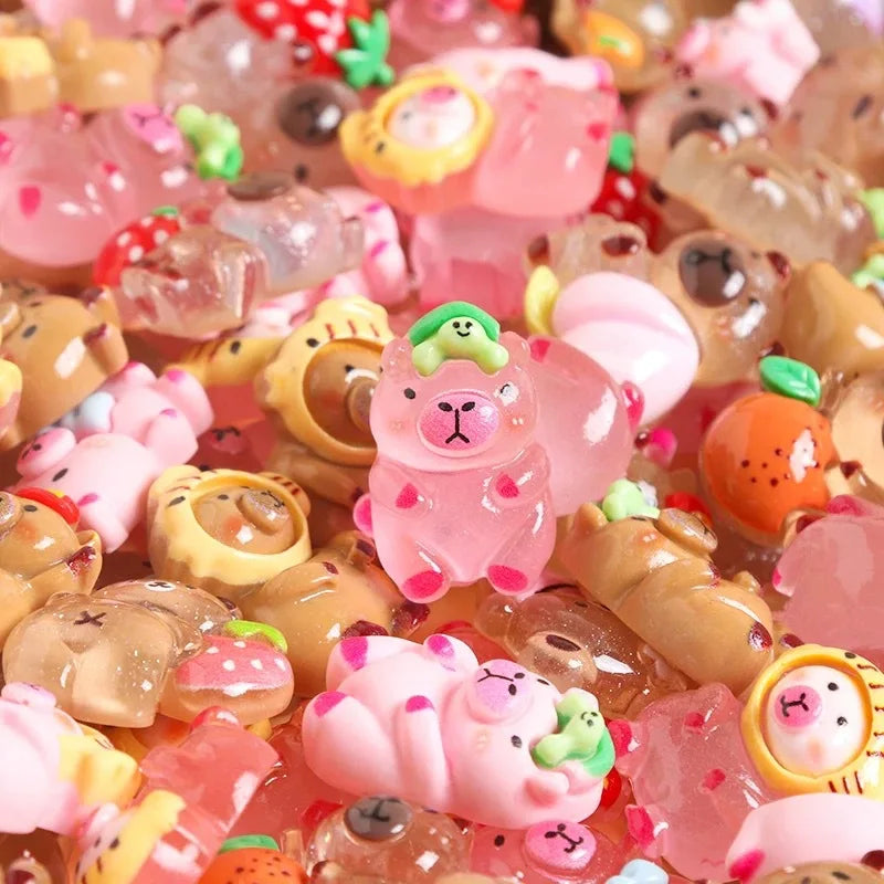 A close-up of colorful mini capybara resin figurines scattered on a surface for desk decor and crafts.
