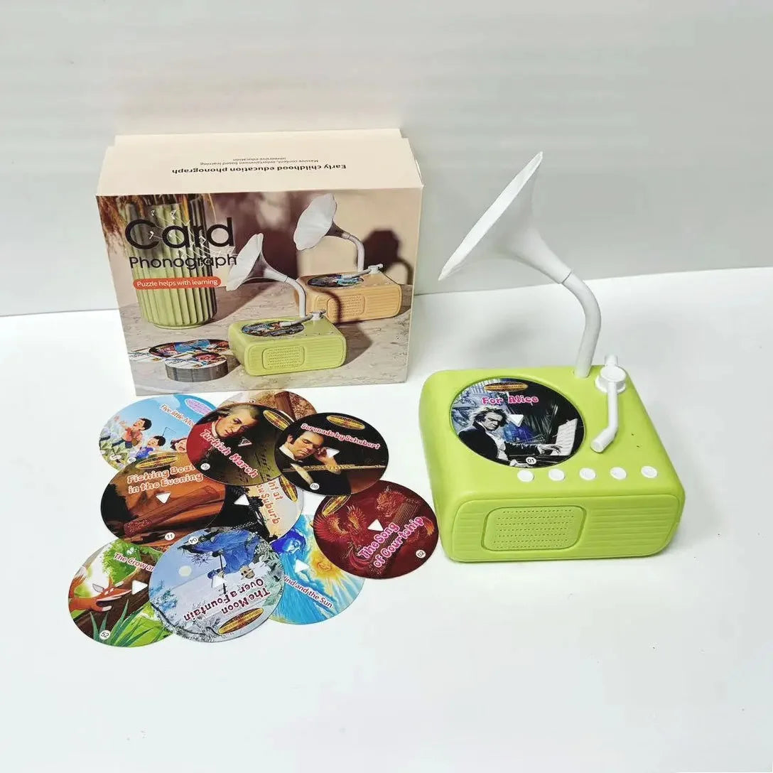 A green interactive card reader device and a cardboard box with learning cards are displayed on a white surface.