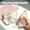 A clear plastic bottle squishy toy is shown next to a pink keyboard and in a hand, demonstrating soft squeeze stress relief.
